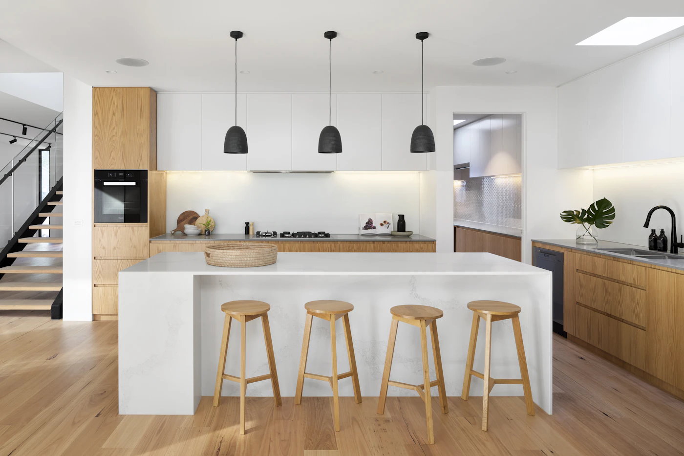Bright remodeled kitchen with natural wood cabinetry and a broad white island